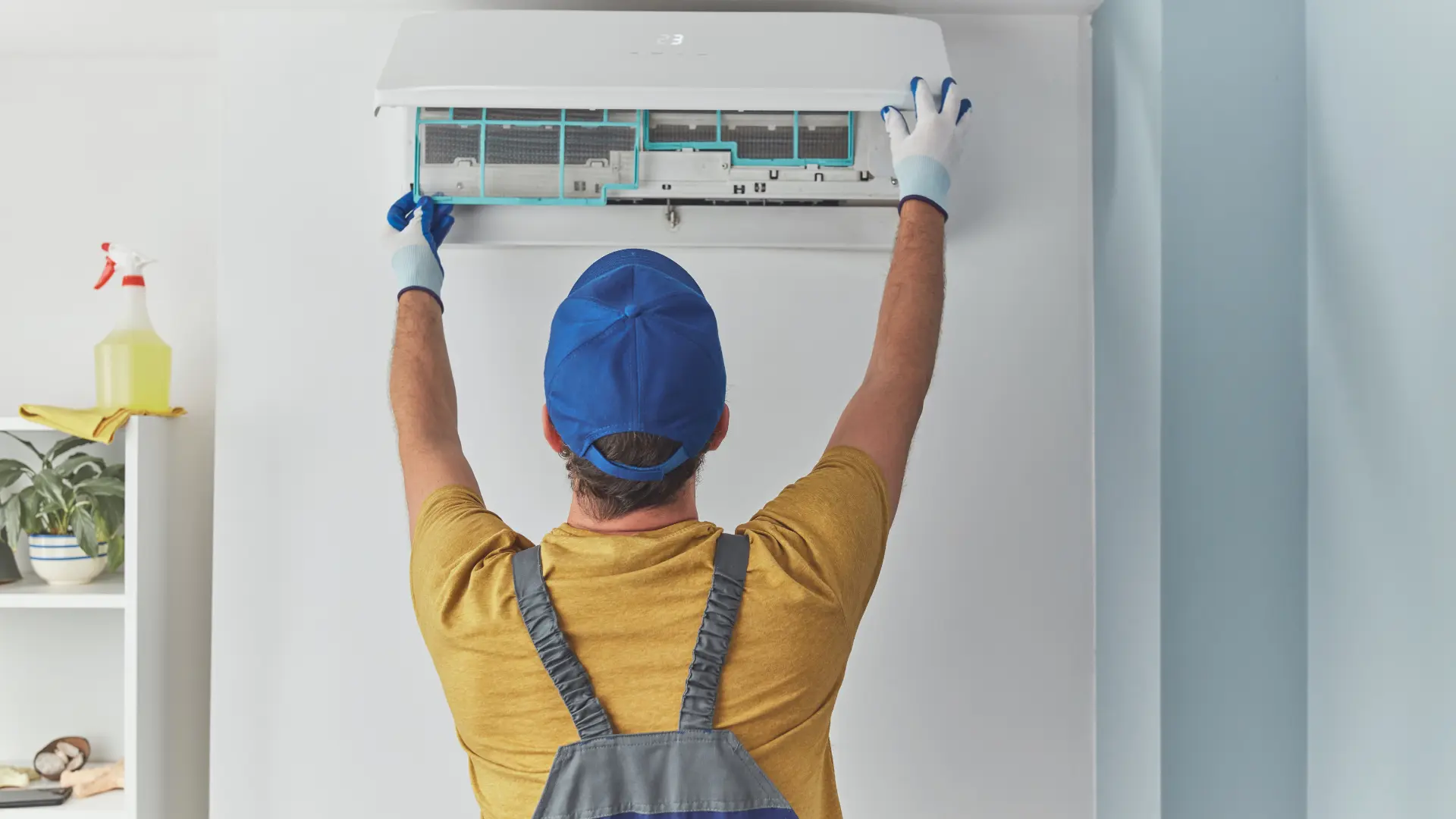 Professional AC technician repairing split air conditioner in a Dubai home