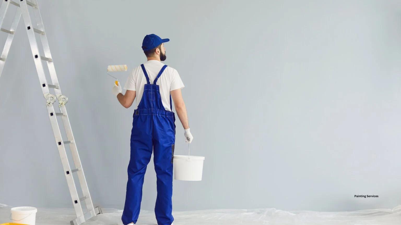 House painting service worker painting interior wall with roller brush